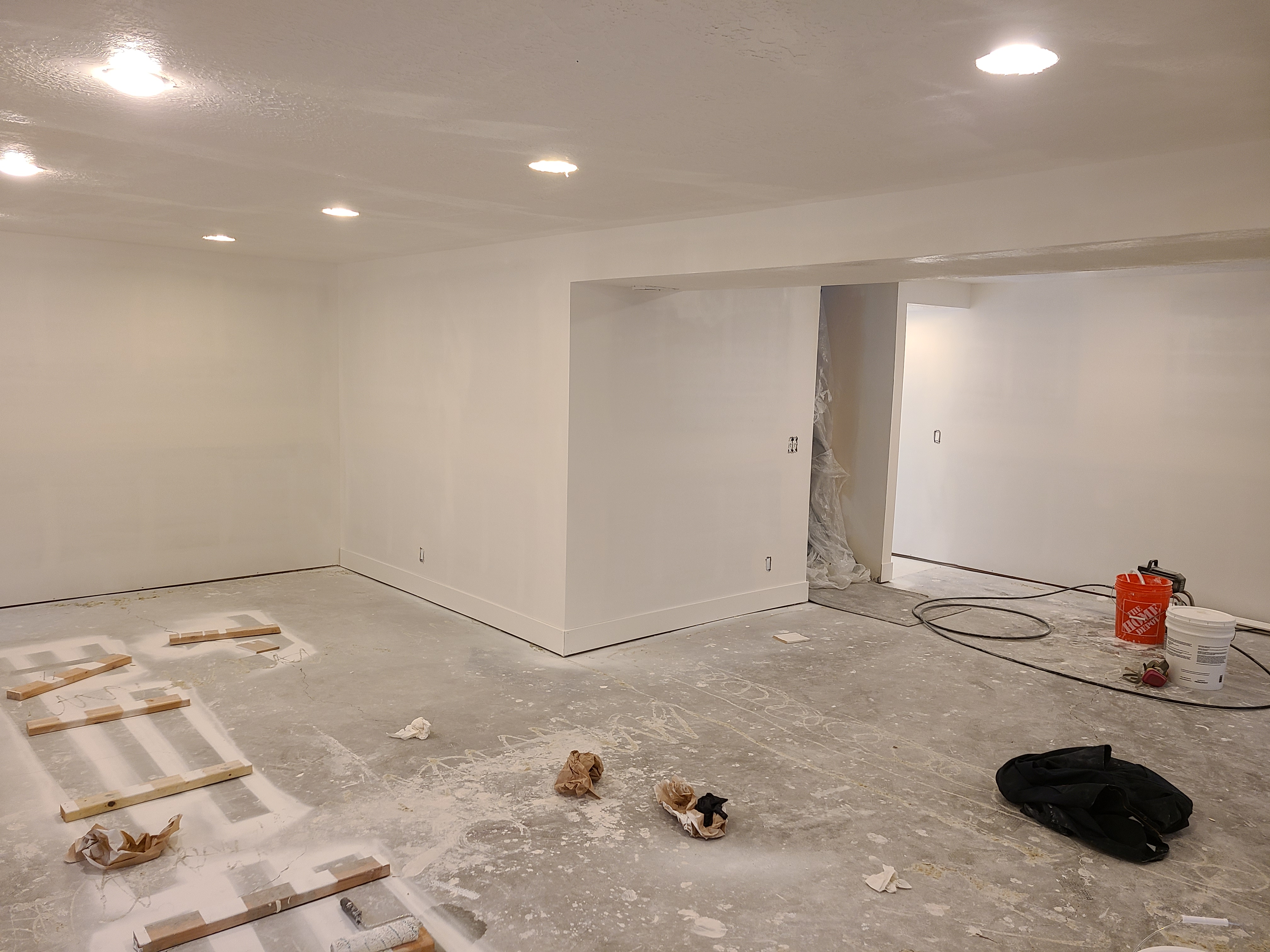 Room remodel in progress with finished walls and recessed lights