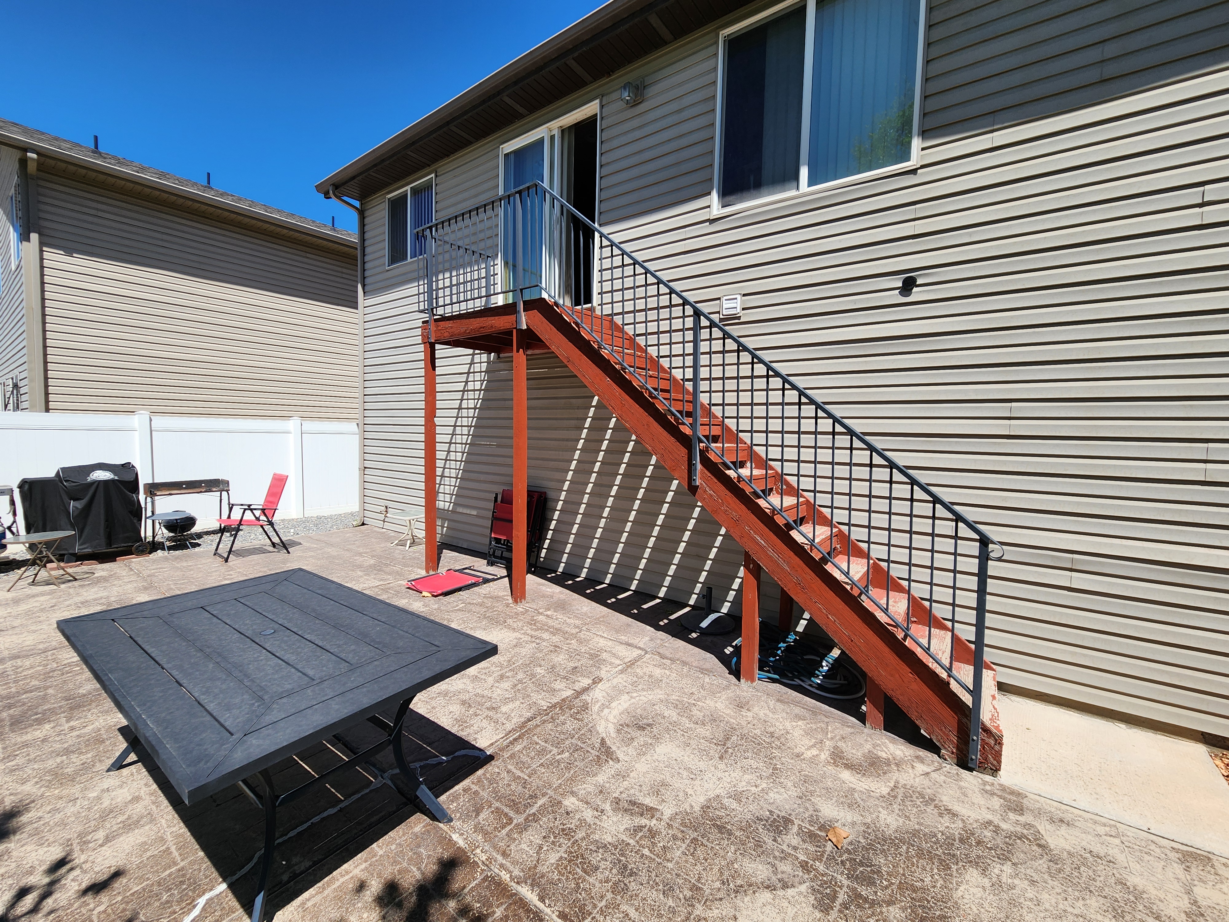 Exterior wood stairs and railings beside a home