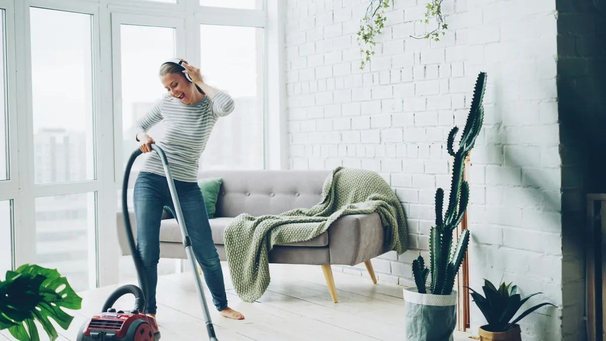 Vacuuming the floor in a bright finished room