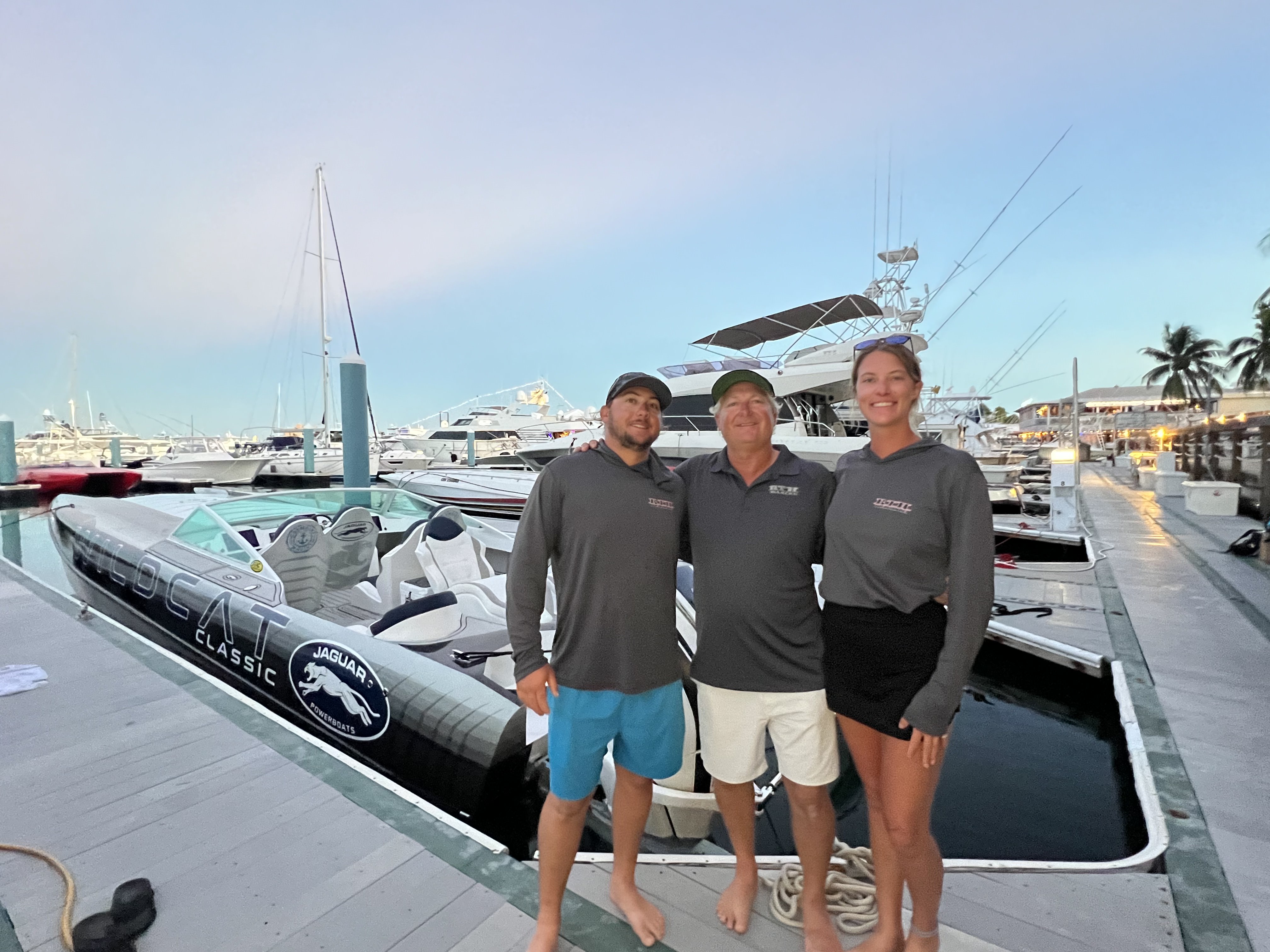 Blye, Tommy, and Abi by a Jaguar powerboat at the Key West Poker Run