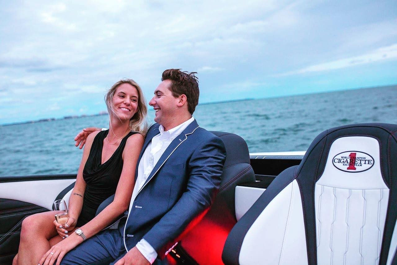 Abigail Doxey and Blye Hofstetter on a cigarette boat