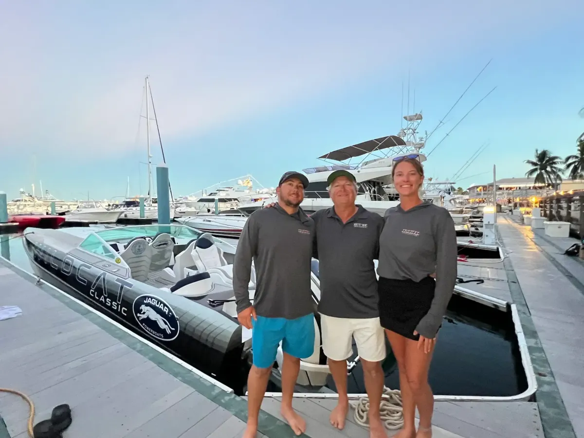 Blye, Tommy, and Abi by a Jaguar powerboat at the Key West Poker Run