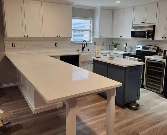 White kitchen cabinets and countertop in a modern kitchen.