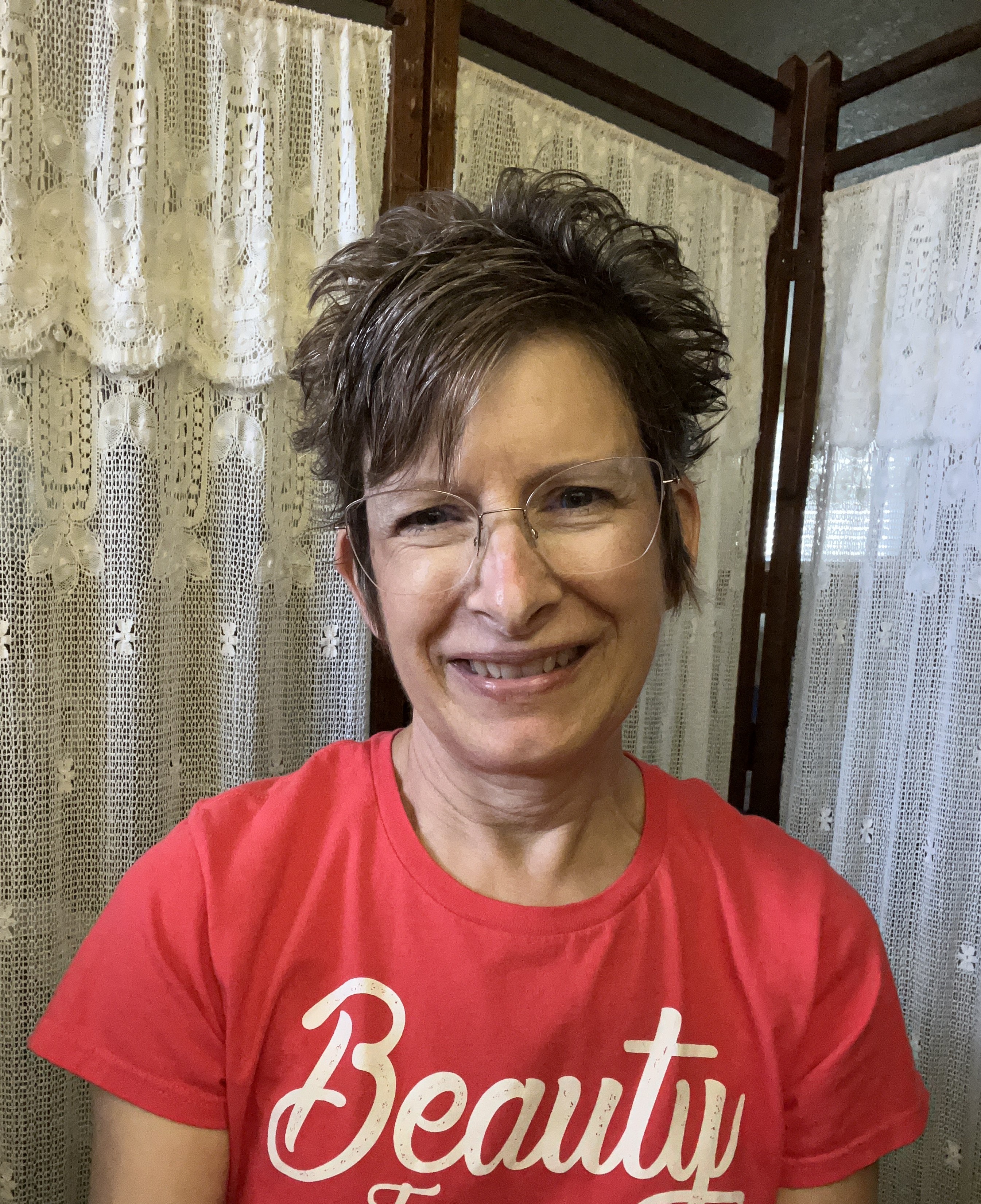short-haired black cat besides brown wooden table