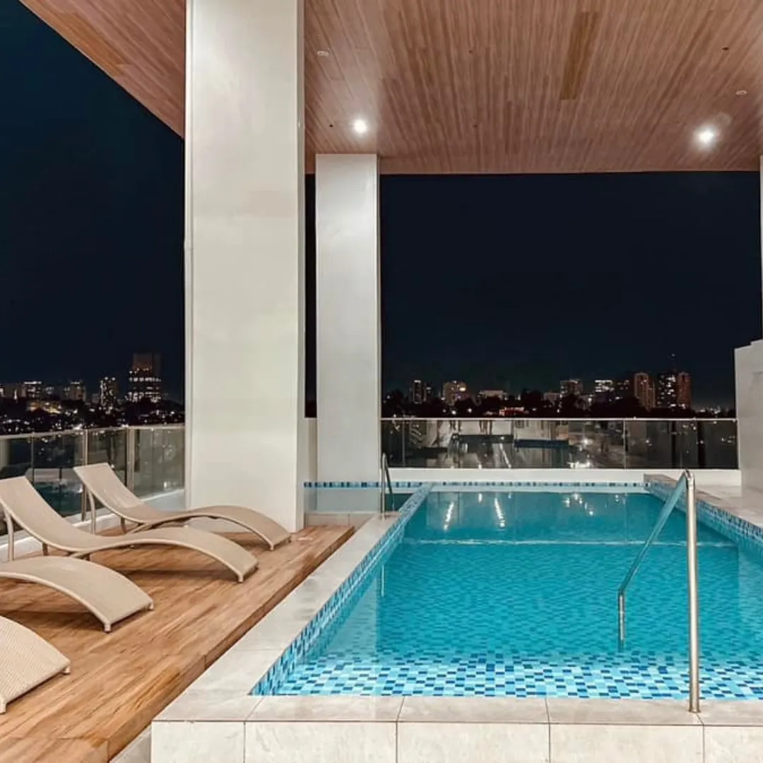 A bathroom with a bench and tiled walls