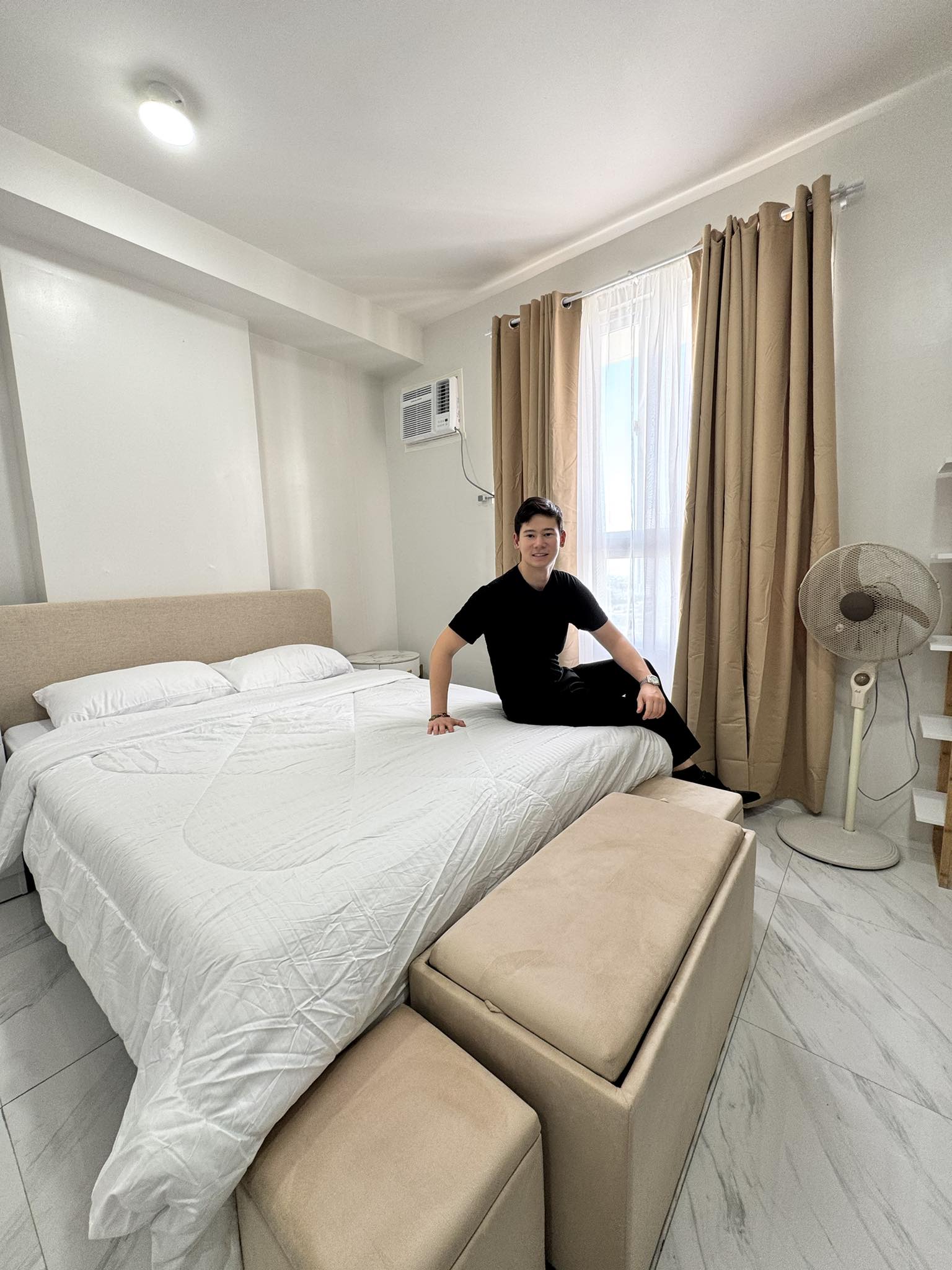 a living room filled with furniture and a happy customer