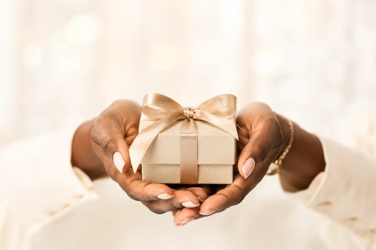 Hands beautifully wrapping a custom keepsake box
