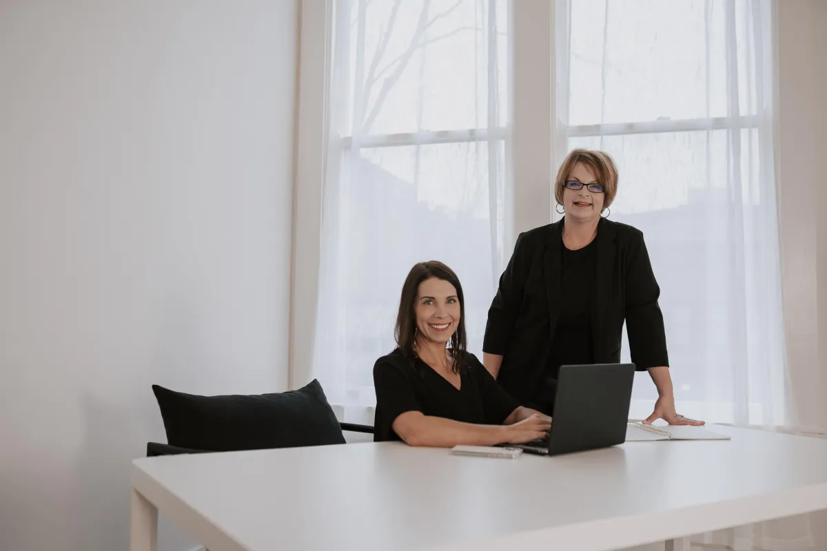 MacBook Pro on table beside white iMac and Magic Mouse