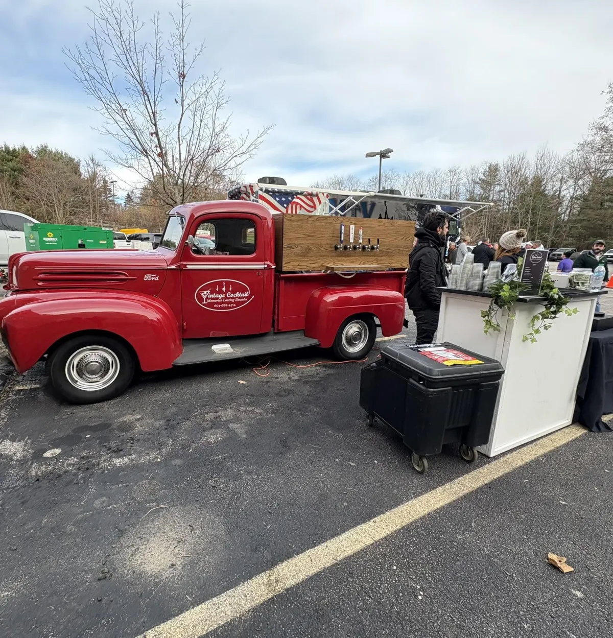 Mike Palmer, holding a bottle of cabernet at a wedding event. Mike is the owner and lead bartender of Vintage Cocktail in New Hampshire 