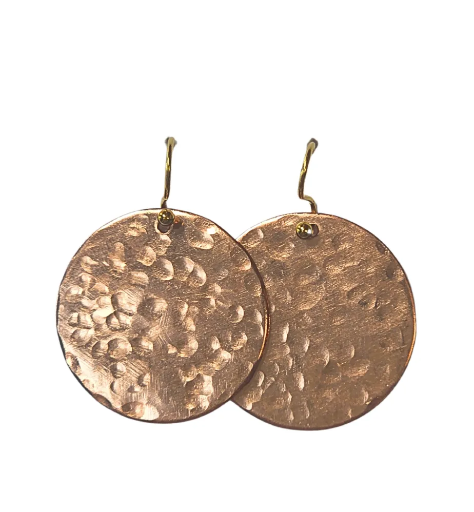 Minimalist gold necklace displayed on soft fabric