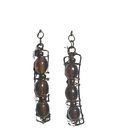 Minimalist gold necklace displayed on soft fabric