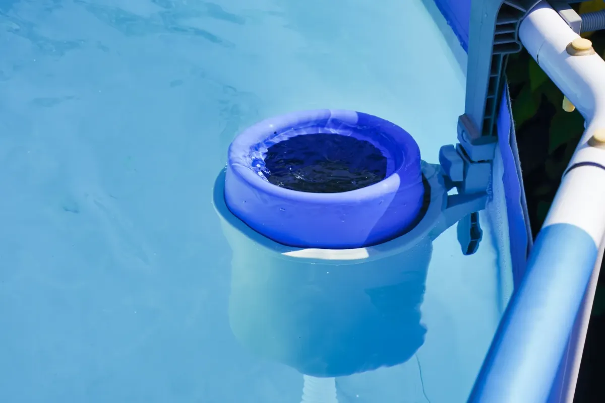 Weekly Pool Maintenance Oak Hill FL — technician skimming a backyard pool — Knight Institutes, LLC