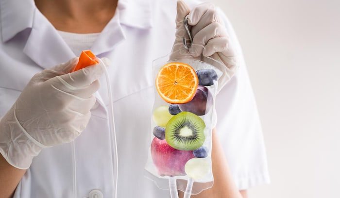 Woman holding fruit for IV therapy