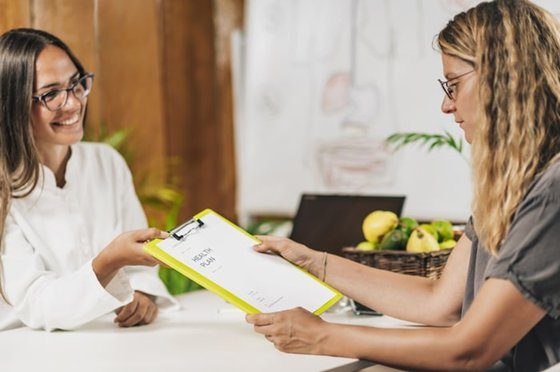 Two women reviewing a chart