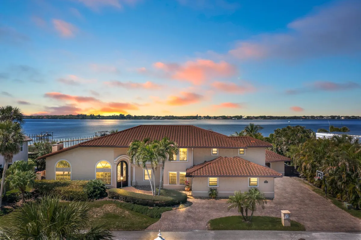 Aerial view of luxury riverfront home with private dock in Tortoise Island, Satellite Beach
