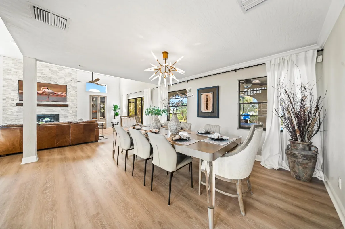 Formal dining room with elegant finishes and waterfront backdrop
