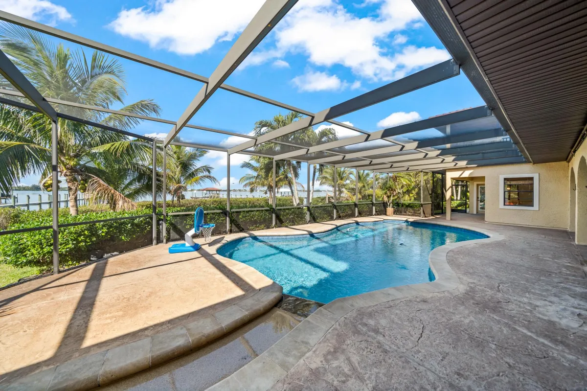 Custom pool and spa overlooking the Banana River with tropical landscaping