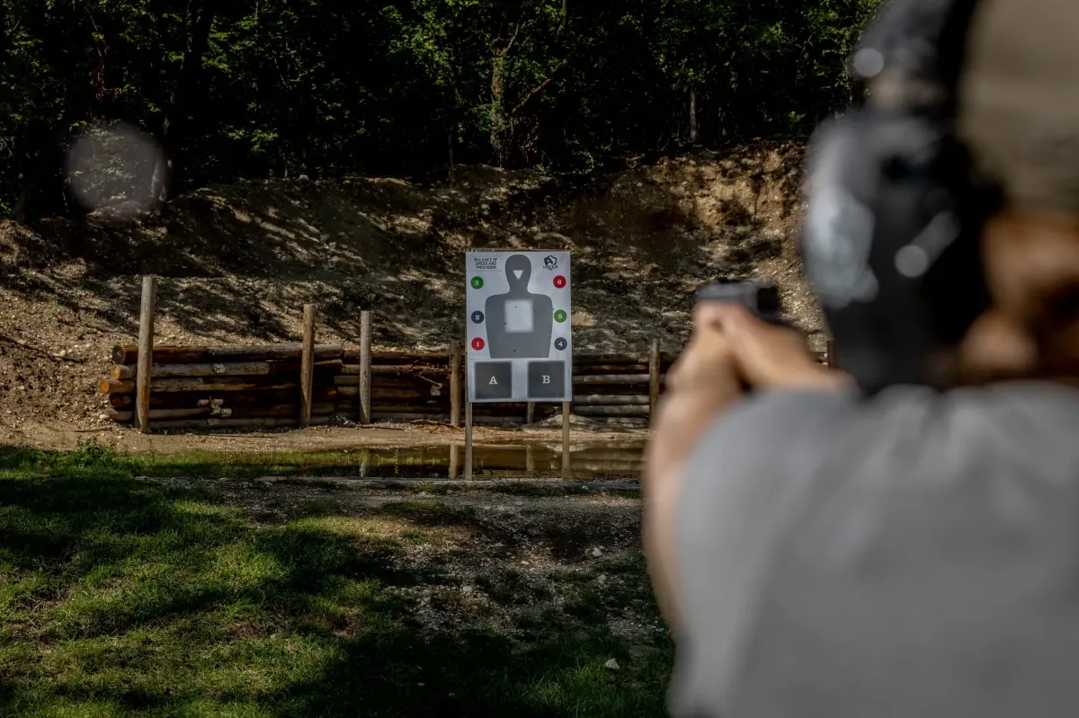 man sitting on chair beside laptop computer and teacup