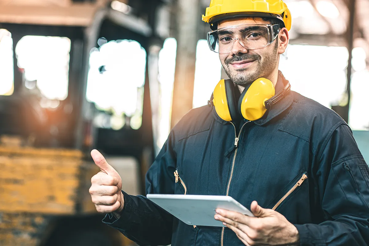 A diverse group of adult learners, including men and women of various ethnicities, attentively participating in a modern classroom setting with laptops open, a digital whiteboard displaying IBM Maximo interface, and an instructor guiding them. Bright, professional, 3:2 aspect ratio.
