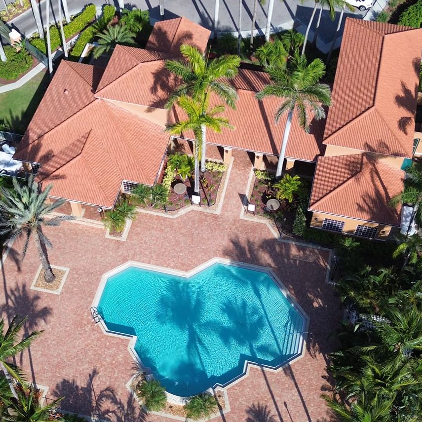 Resort Pool Paradise: "Heated resort pool with lounge chairs in active community at Royal Palm Retreat, amenities for your monthly vacation rental in Naples."