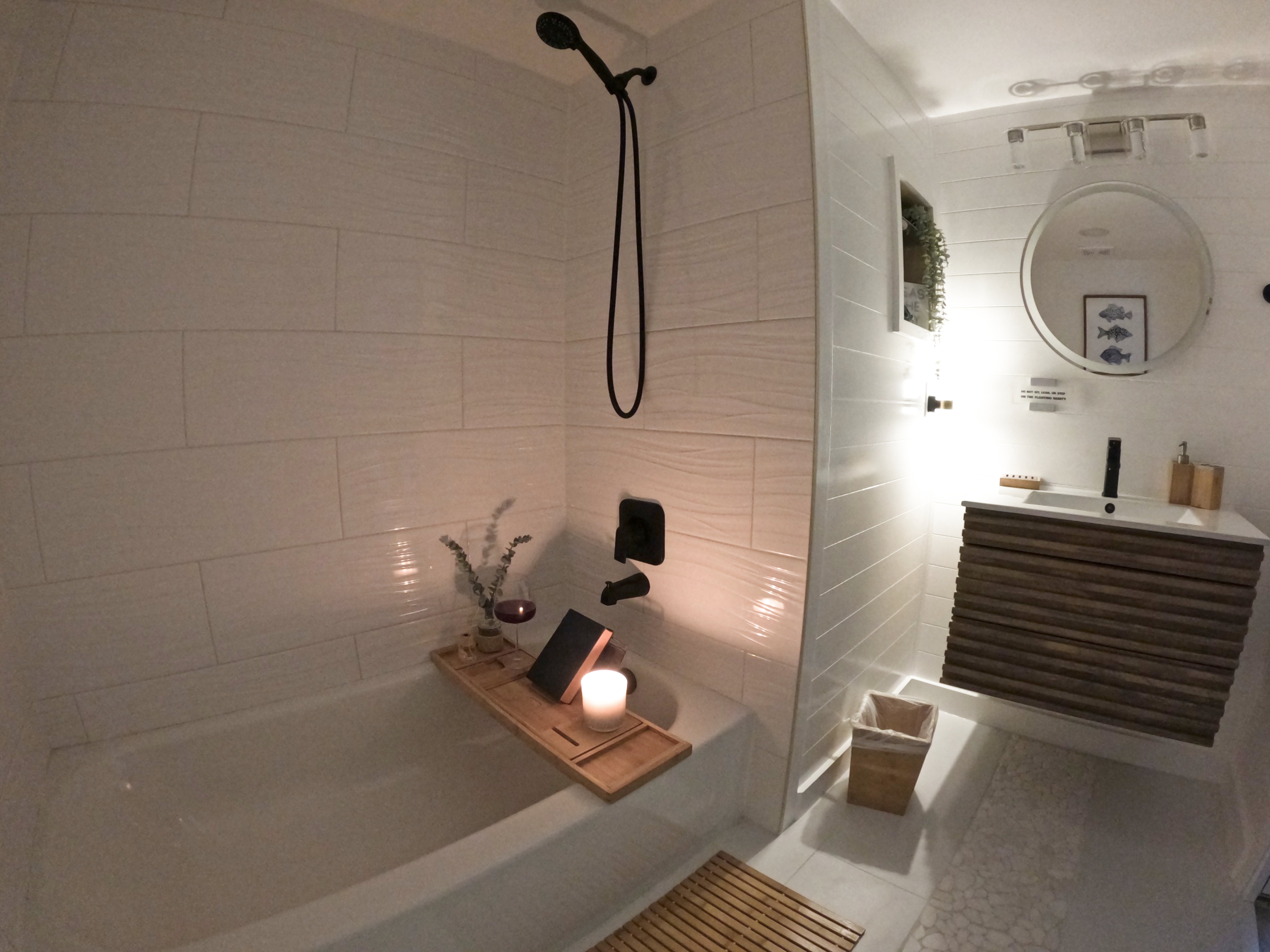 Bathroom Bright & Clean: "Bright white bathroom with beachy sconces in 2BA navy blue condo, luxurious details for your snowbird monthly stay in Naples FL."