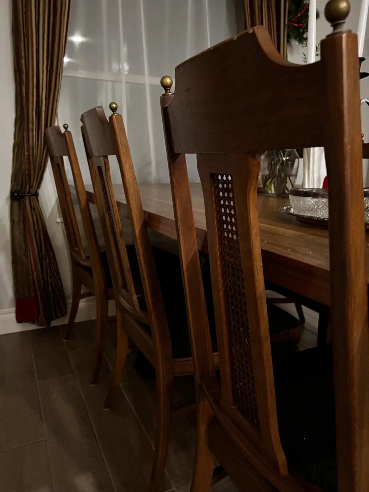 Elegant handcrafted wooden chairs with intricate brass tops, showcasing The Manor's collection of fine vintage furniture.