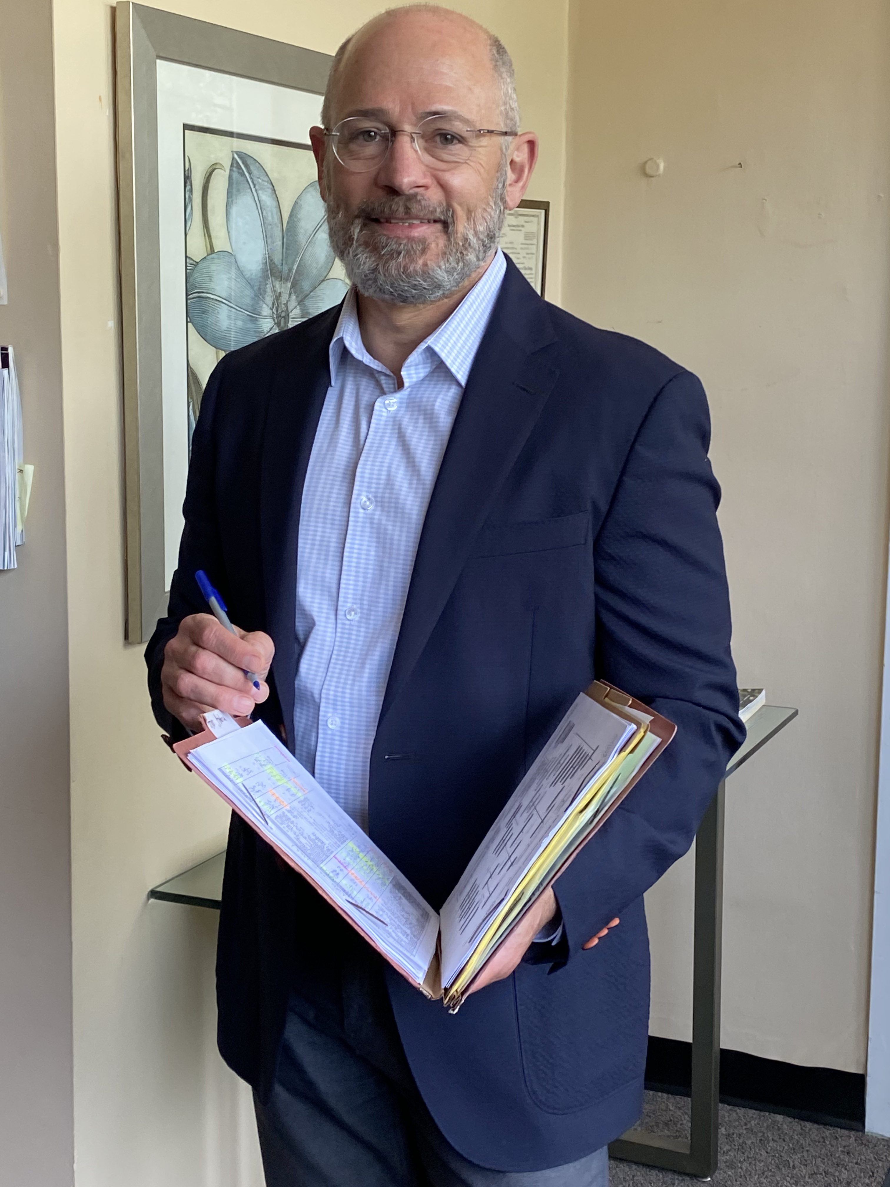 Dr. Douglas Pucci reviewing a patient file, representing guided clinical insight and a deeper look at cholesterol patterns