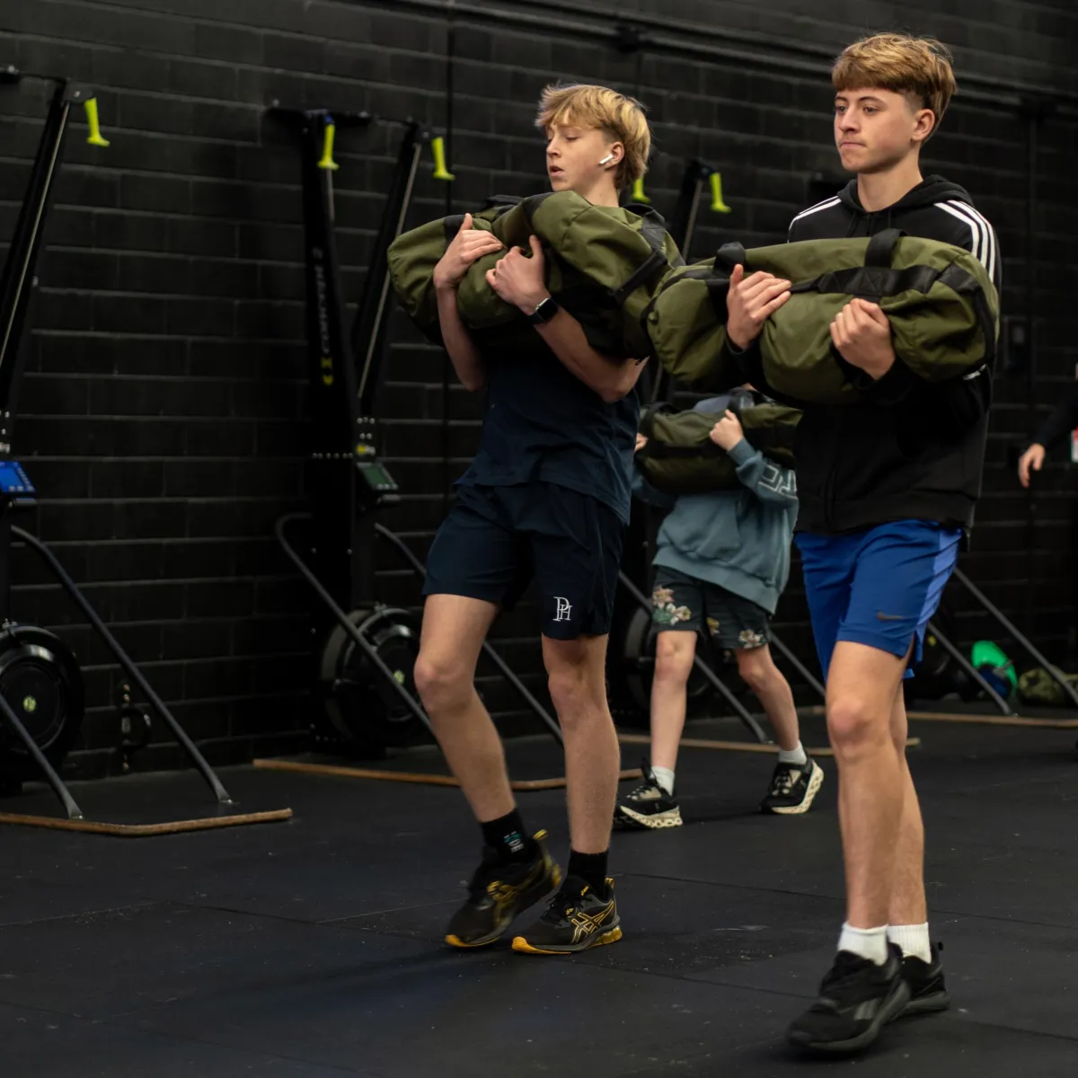 Beginner learning proper form with coach at Code 5 Brookvale gym to build strength and confidence