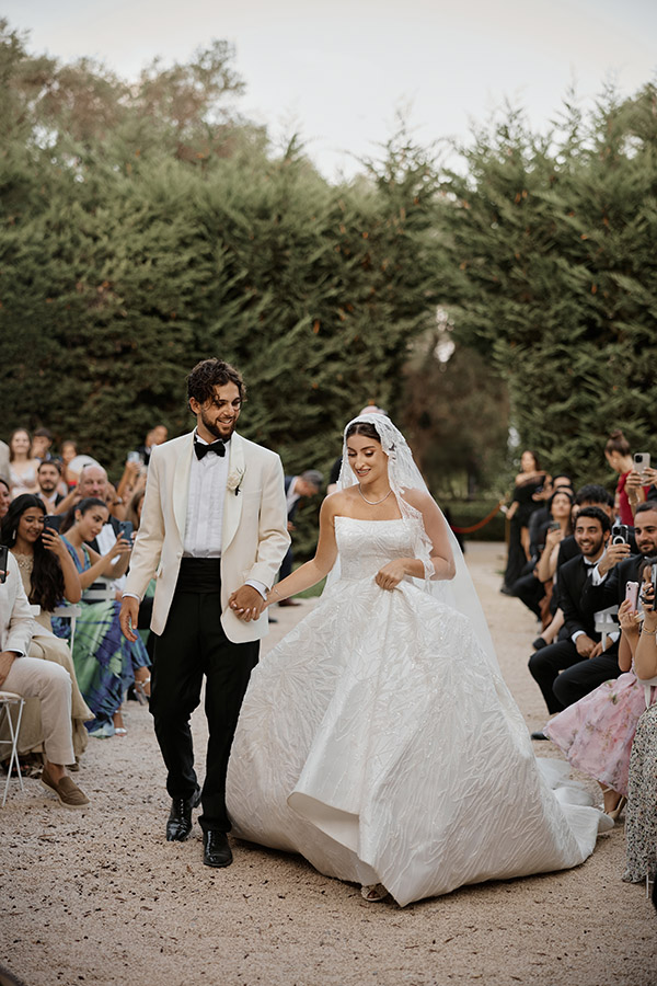 Elegant wedding couple posing in the French gardens of Palace Mala Wies near Warsaw, Poland.