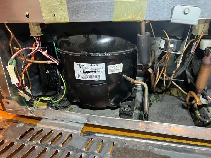 Gas stove burner and ignition system being serviced by licensed technician from Sammy Appliance Repair