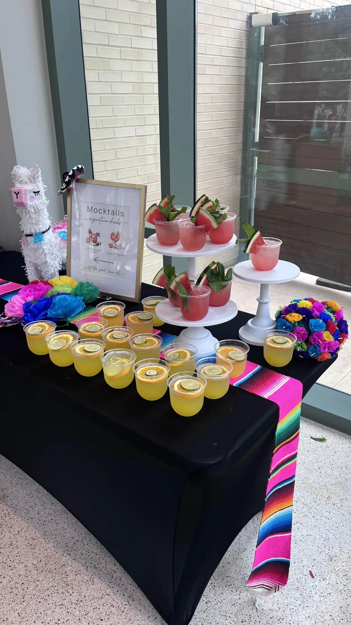 Colorful cocktail display at a Shake Rattle & Roll corporate event, featuring signature drinks prepped by a professional bartender with festive decor and branding elements