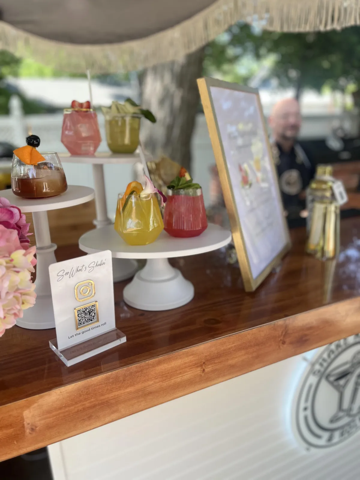 Custom mobile bar service with two signature cocktails from the Shakin Package, featuring colorful sample drinks on display in San Antonio event setting