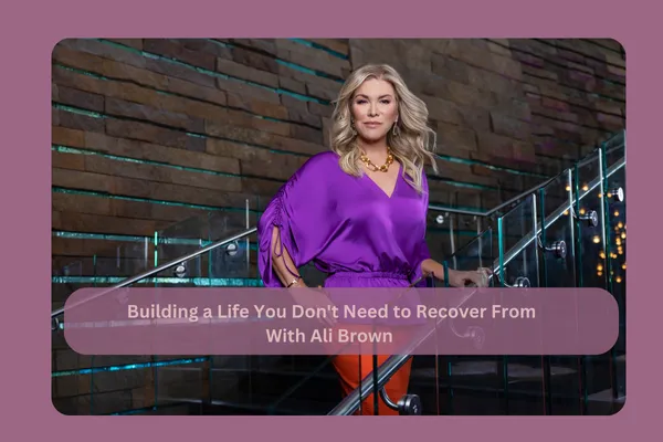 Ali Brown standing on a staircase sharing insights on success, wellness, leadership, and building a fulfilling life.