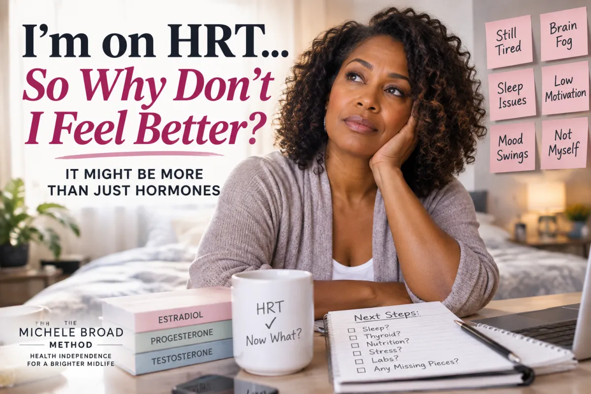 A midlife African American woman sits thoughtfully at a desk, surrounded by reminders of persistent symptoms like fatigue, brain fog, sleep issues, mood changes, and not feeling like herself, despite being on HRT.
