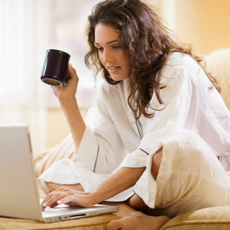 Woman working on a laptop during a 1:1 session with Piper, focusing on personal growth and healing.