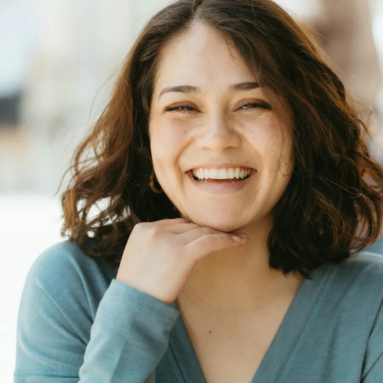 Woman smiling while on her computer inside
