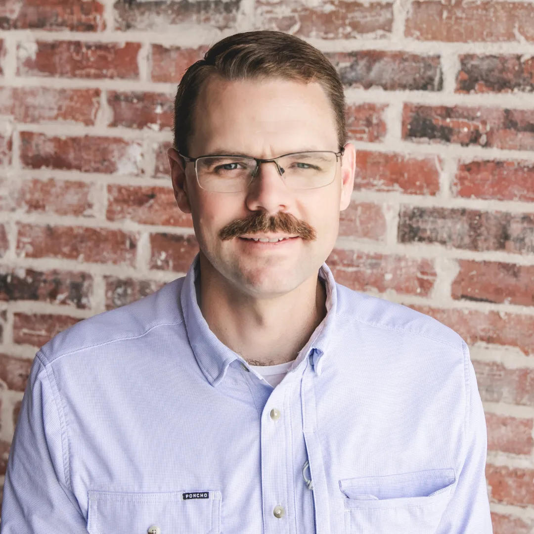 Headshot Of Charlie Clark Smiling In Glasses Leadership Team At 8:12 Roofing And Exteriors