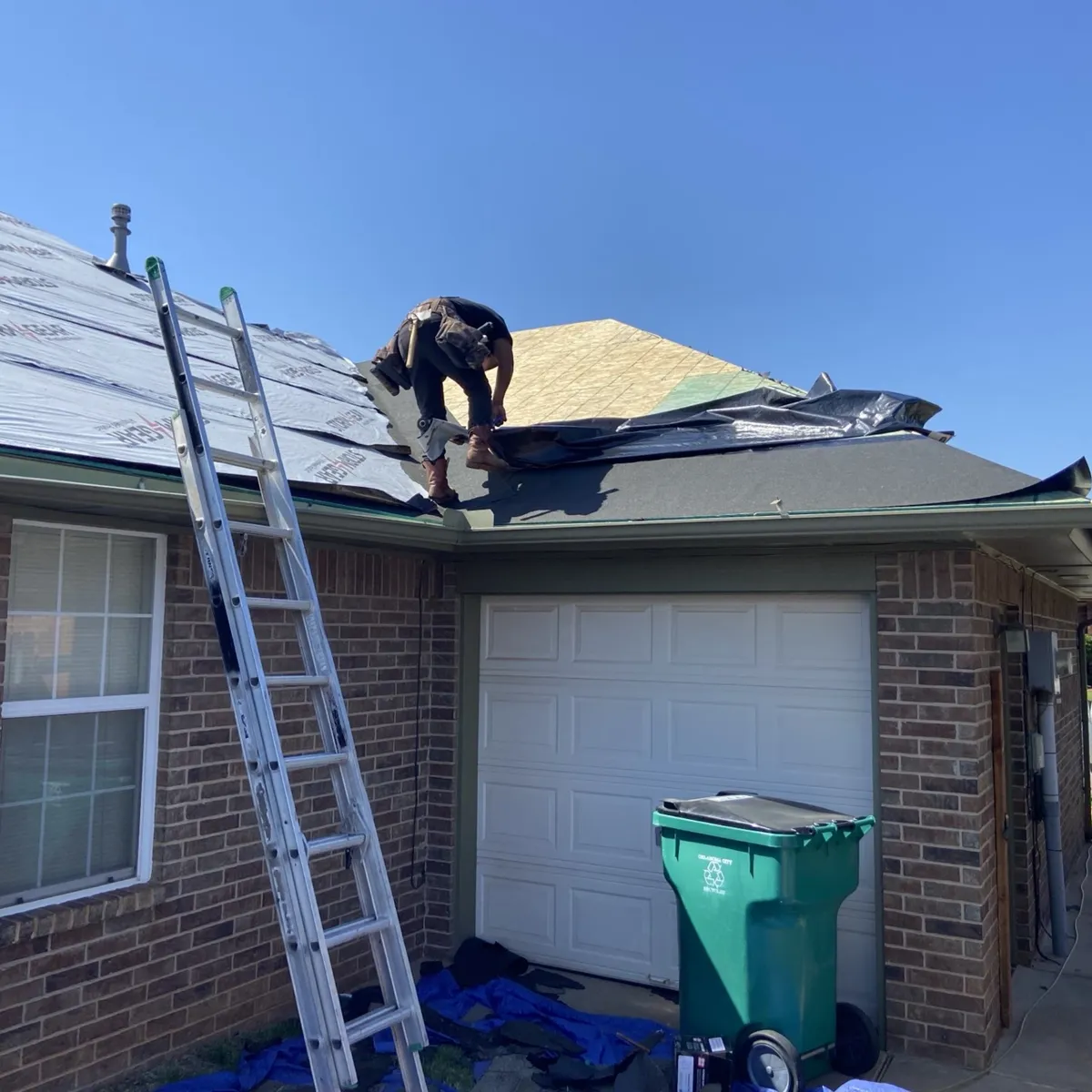 Roofing Crew Replacing Roof On Brick Home In Oklahoma