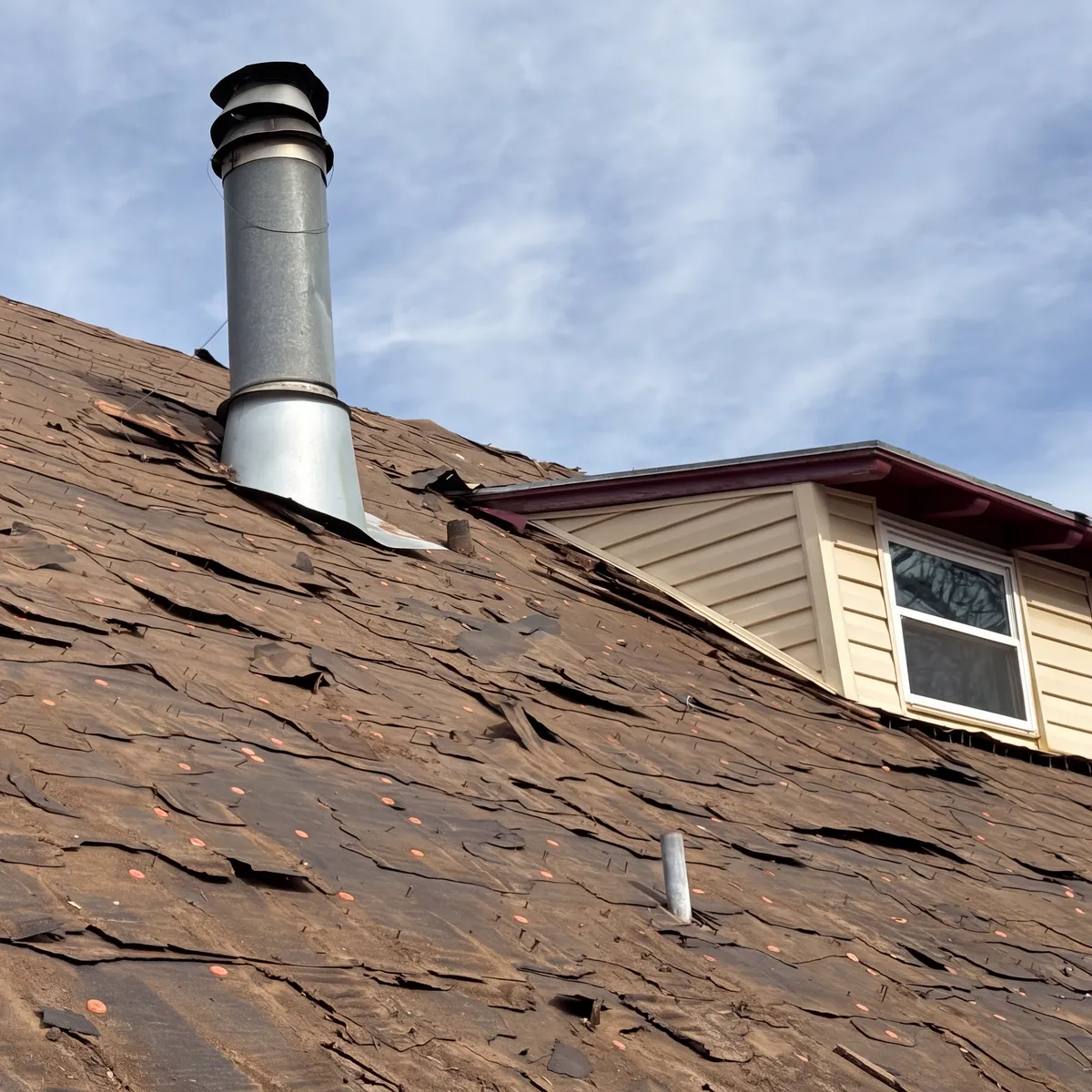 Storm Damaged Roof Vent And Shingles Needing Repair