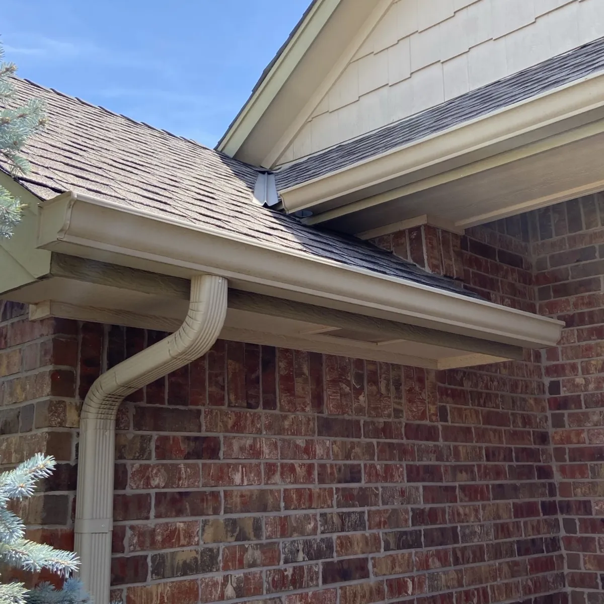 Oklahoma Home Gutter And Downspout Installation On Brick Exterior
