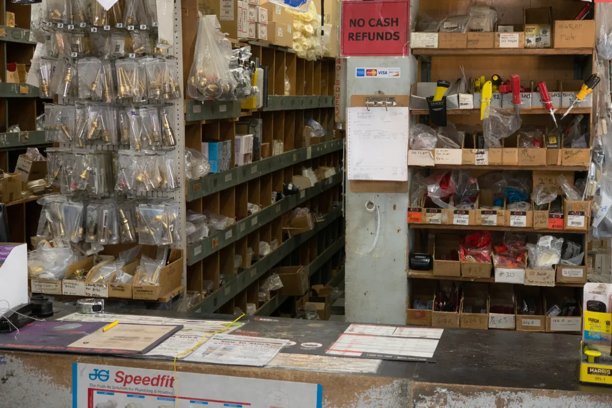 a grassy field with trees and a building in the background