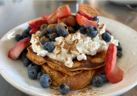 four boy playing ball on green grass