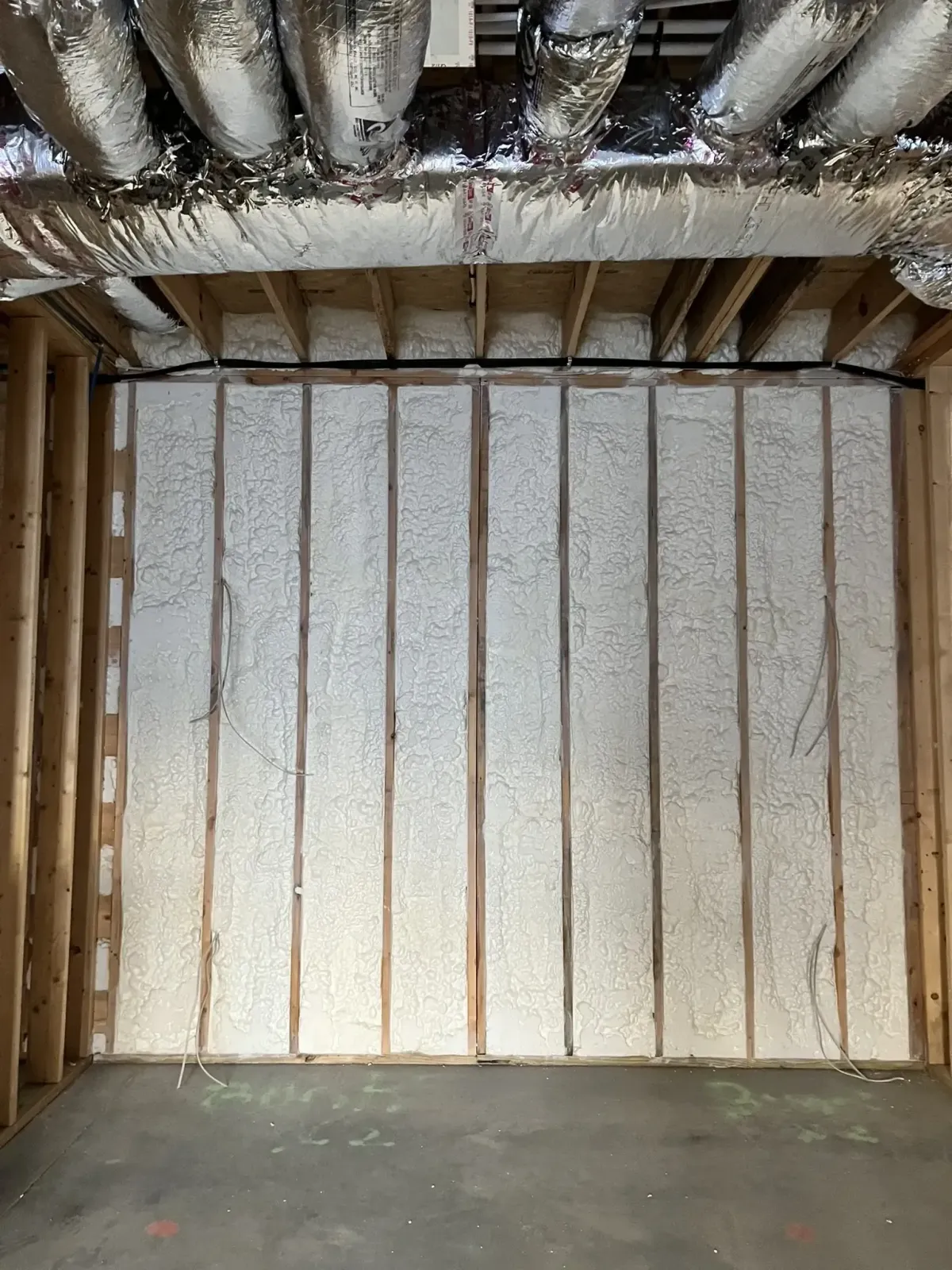 Wall cavity open-cell spray foam insulation in Raleigh home for exceptional energy efficiency and air sealing