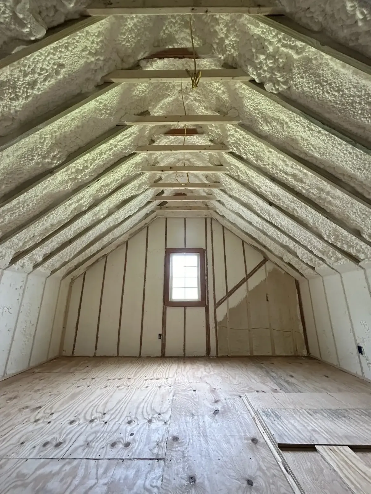 Attic in Raleigh insulated with open-cell spray foam for energy efficiency and moisture control
