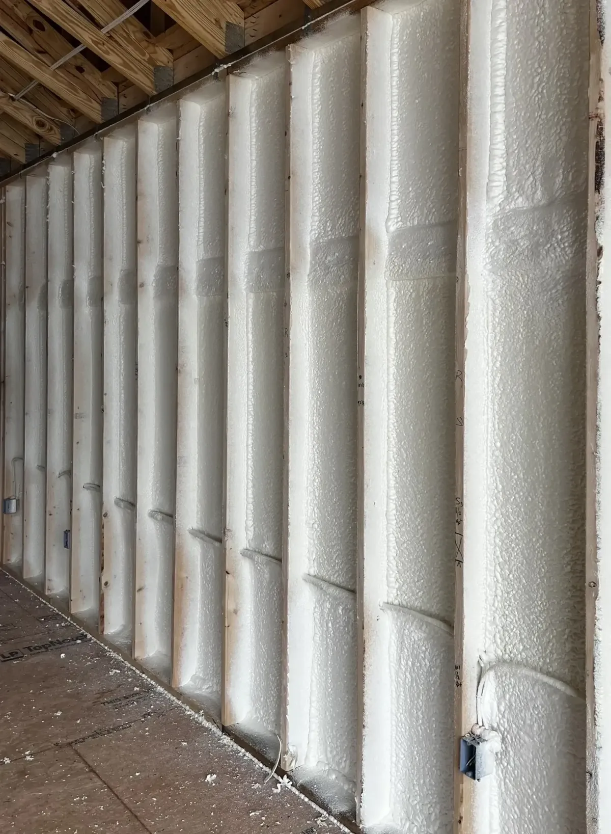 Energy-saving spray foam insulation applied to basement walls in Raleigh