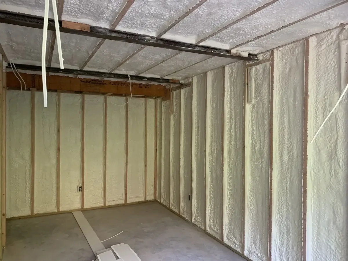 Spray foam applied to basement walls for moisture control in Raleigh