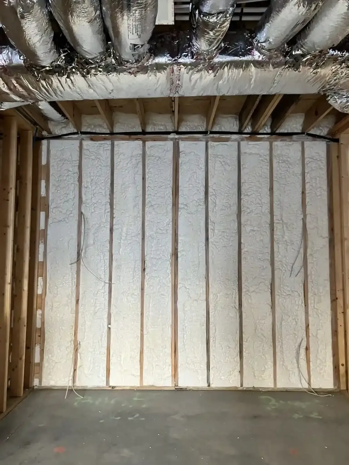 Wall cavity open-cell spray foam insulation in Raleigh home for exceptional energy efficiency and air sealing