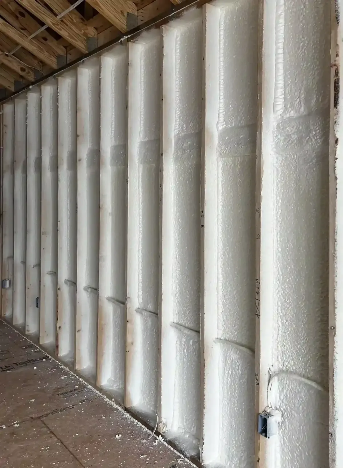 Energy-saving spray foam insulation applied to basement walls in Raleigh