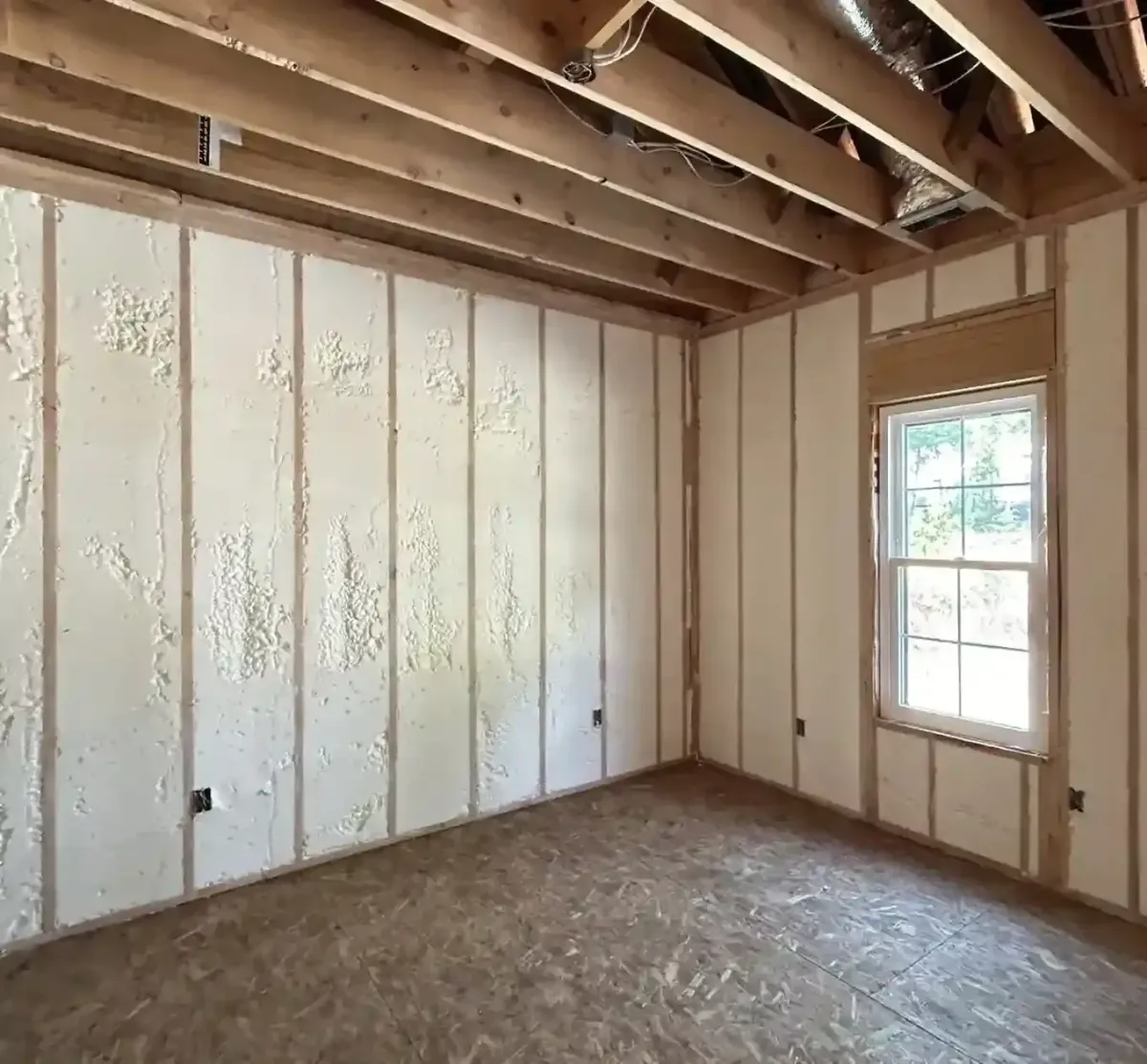 Open-cell spray foam insulation applied to interior walls in new home construction in Clayton, NC for energy savings and sound control