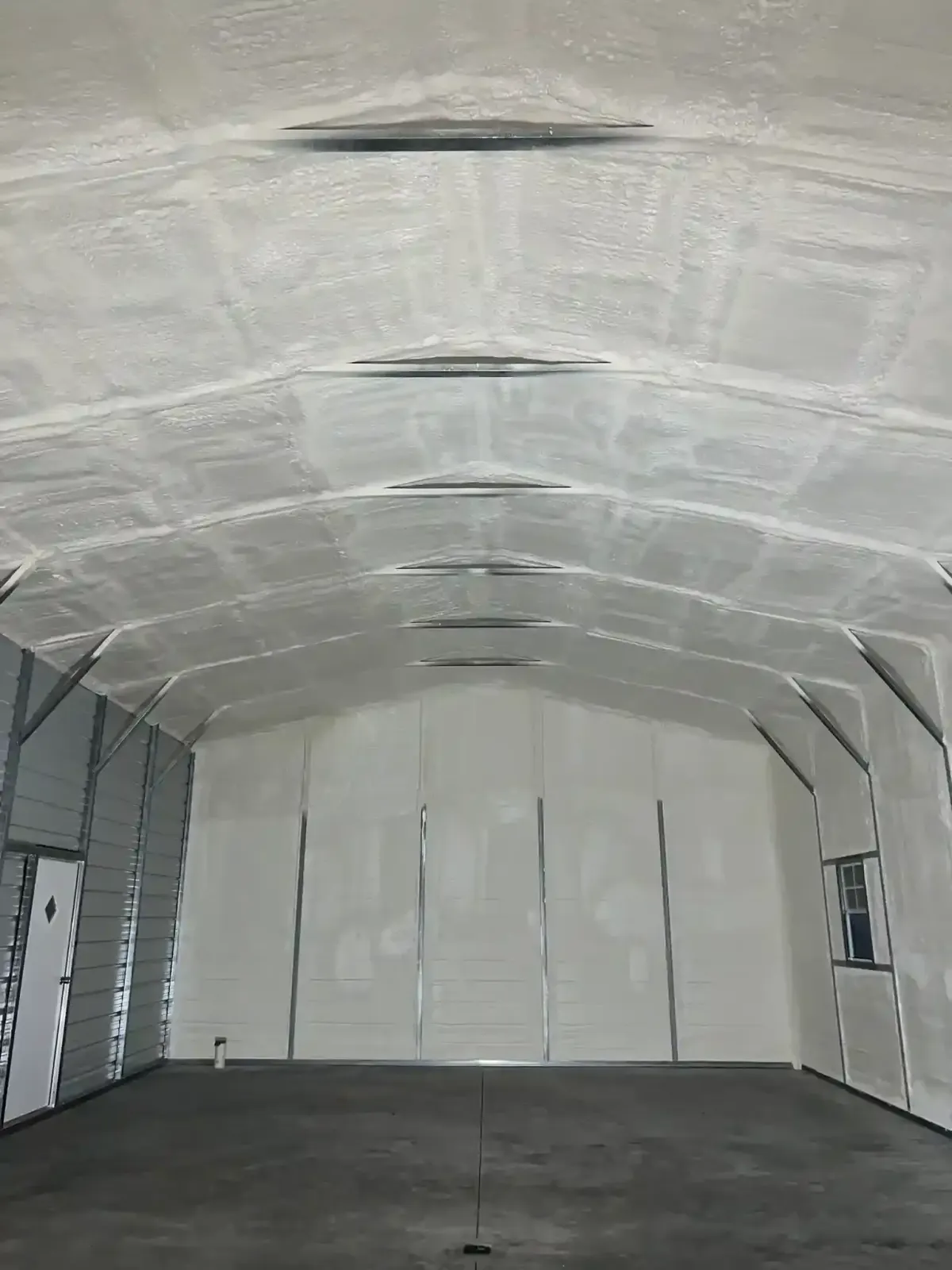 Closed-cell spray foam insulation applied to interior of metal building in Clayton, NC for airtight sealing and energy efficiency